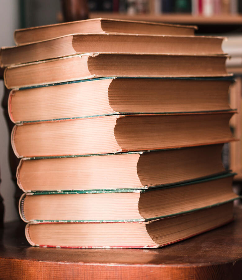 Stack of vintage books — browse the Wilding Within reading list